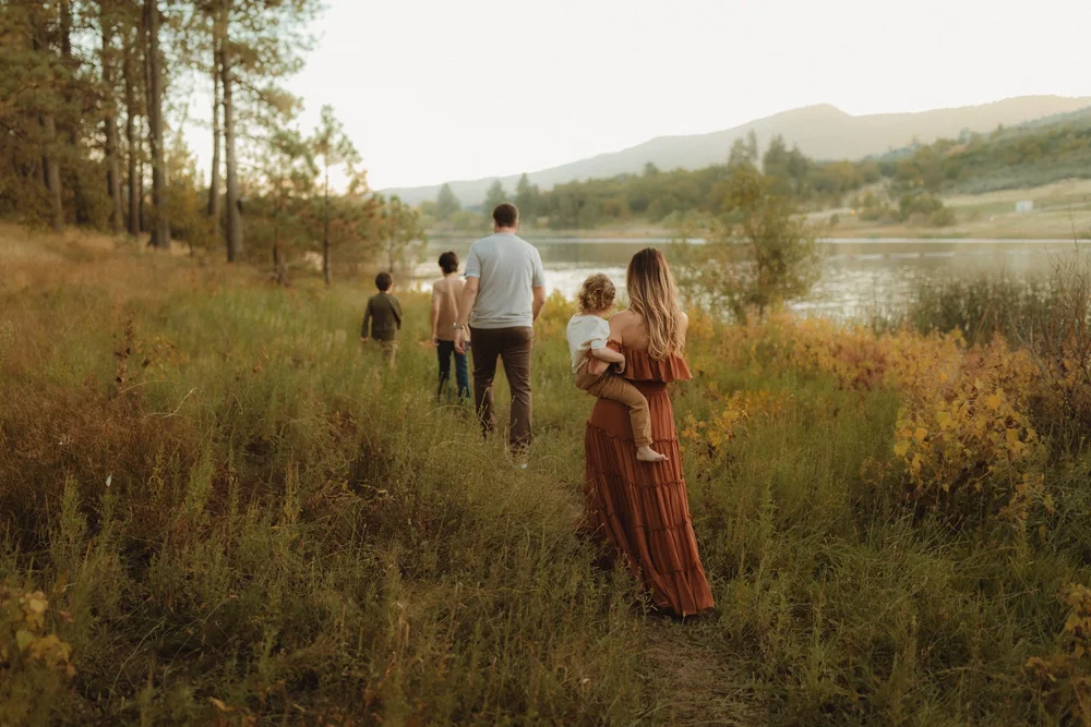 Family of five walking along a lake in San Diego